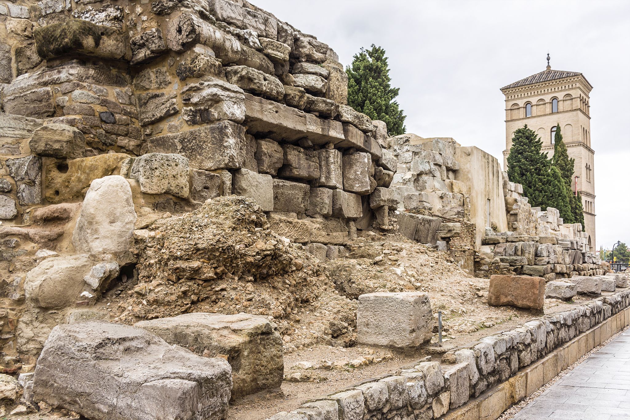 Photo of Roman Walls in downtown: Avenida Cesar Augusto (2nd - 3rd centuries A.D.). There is a fortified tower followed by walls. These were used to defend the city during the Middle Ages. Zaragoza, Spain.