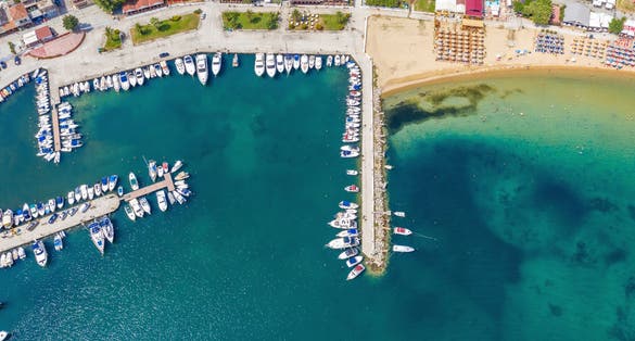 Photo of aerial view of harbor of boats in Kavala, Greece.