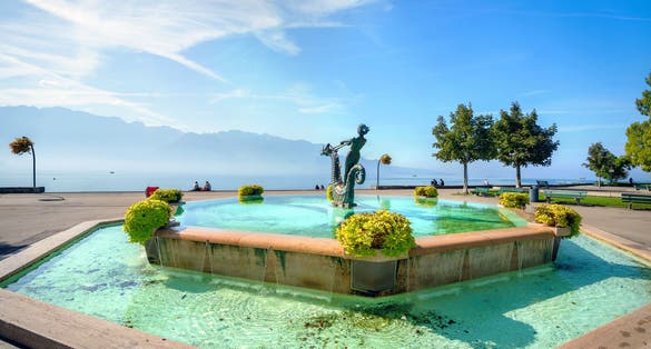 Photo of beautiful fountain on seafront in Vevey town, Lake Geneva, Vaud canton, Switzerland.