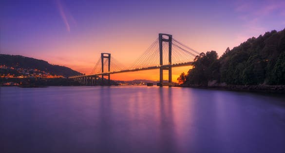 Photo of sunset in the Ria de Vigo with the Rande bridge in the background.
