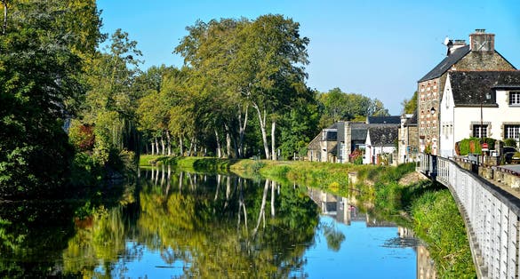 River Oust, part of canal Nantes at Brest, and big reflections of trees in water at Josselin, a commune in the Morbihan department in Brittany in north-western.