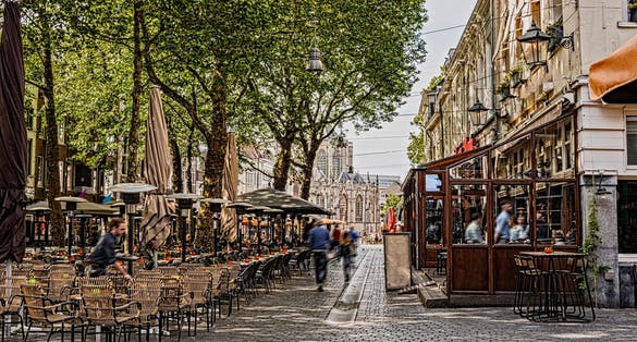photo of view of walk and restaurant terraces in the center of the city of breda in the background you can see the great church. Netherlands N.