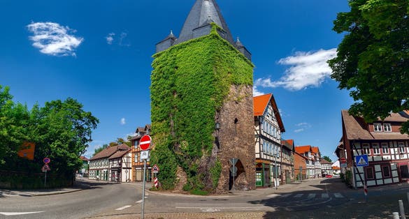 Westerntor Tower in Wernigerode, Germany, is a historic medieval tower covered in ivy, situated at a key intersection in the town