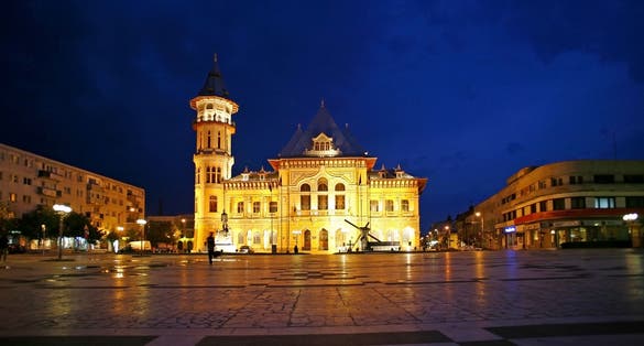 Buzau city hall at night, Romania.The Communal Palace in Dacia Square, BuzÃ?Â?u