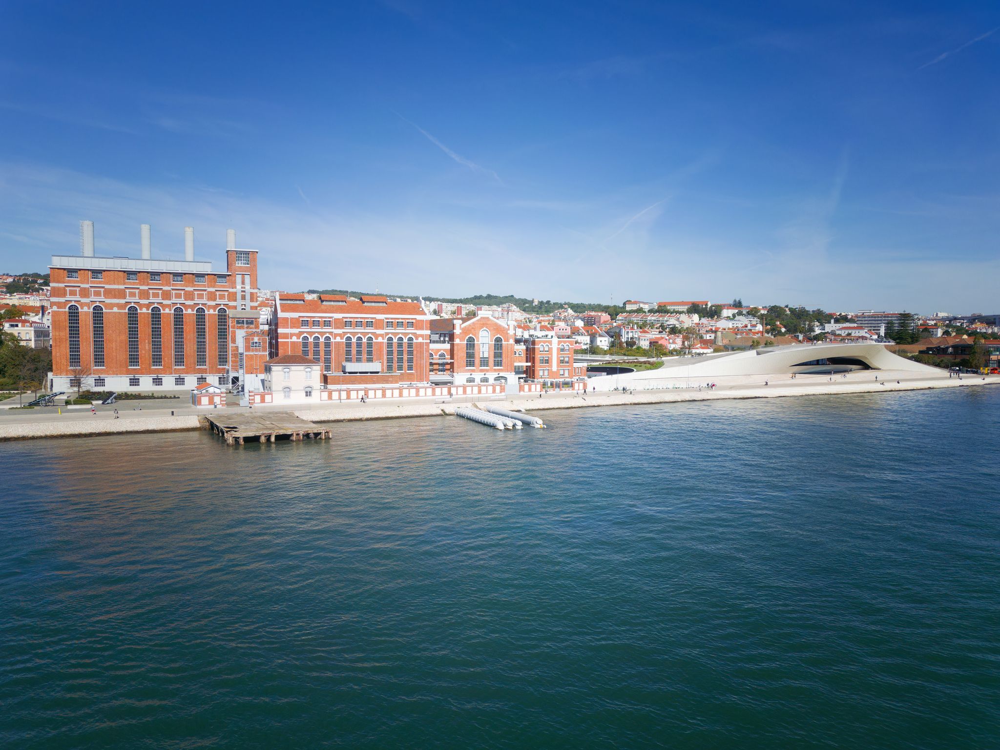 Aerial drone view of cityscape of Lisbon, Portugal. Tagus Tejo river with EDP Electricity Museum and MAAT - Museum of Art, Architecture and Technology in the background. Digital Nomad World.