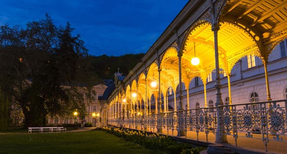 Photo of Park Colonnade with wooden arbor and lights in Dvorak Park Dvorakovy sady in Karlovy Vary (Carlsbad) historical city centre, Czech Republic.