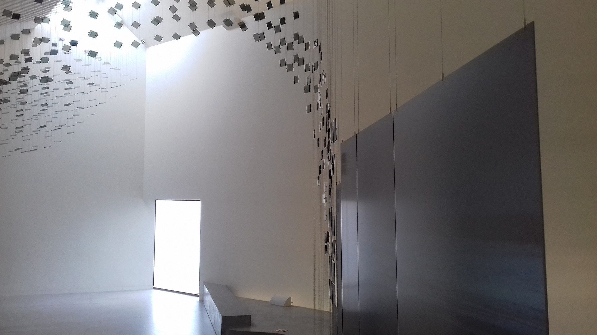 Photo of the interior of Wadden Sea Centre the final room in the exhibition features an artwork of glass with video projections showing the flight of birds, Denmark.