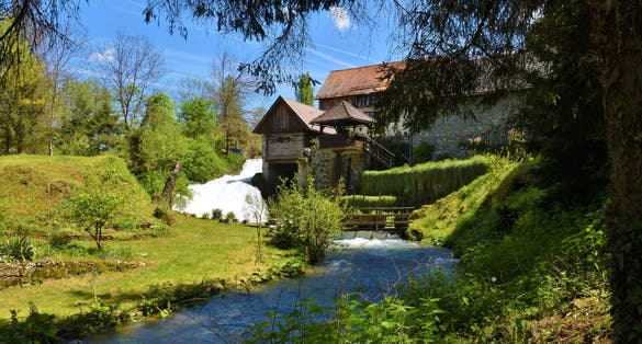 photo of view of Buildings in the town of Slunj in Karlovac county, Croatia with a stream flowing next to the buildings