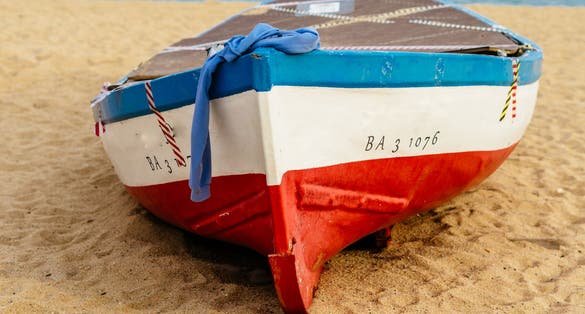 Old fishing boat on Badalona beach, Barcelona, Spain.