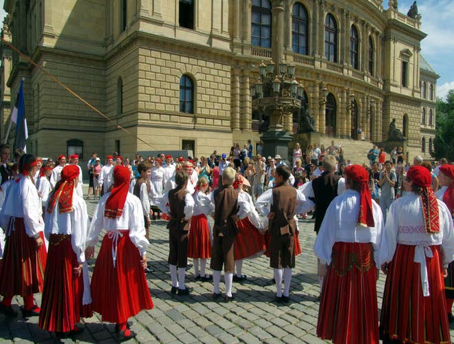 Folk dancers in traditional costumes performing in a public square during Prague Folklore Days in Czechia in July..jpg