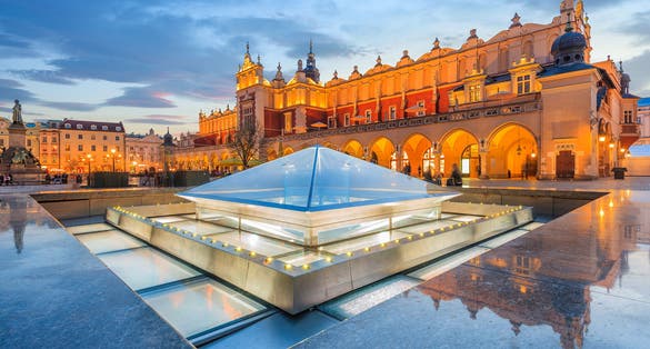 Photo of cloth Hall Sukiennice building at night on main square of Krakow city, Poland.