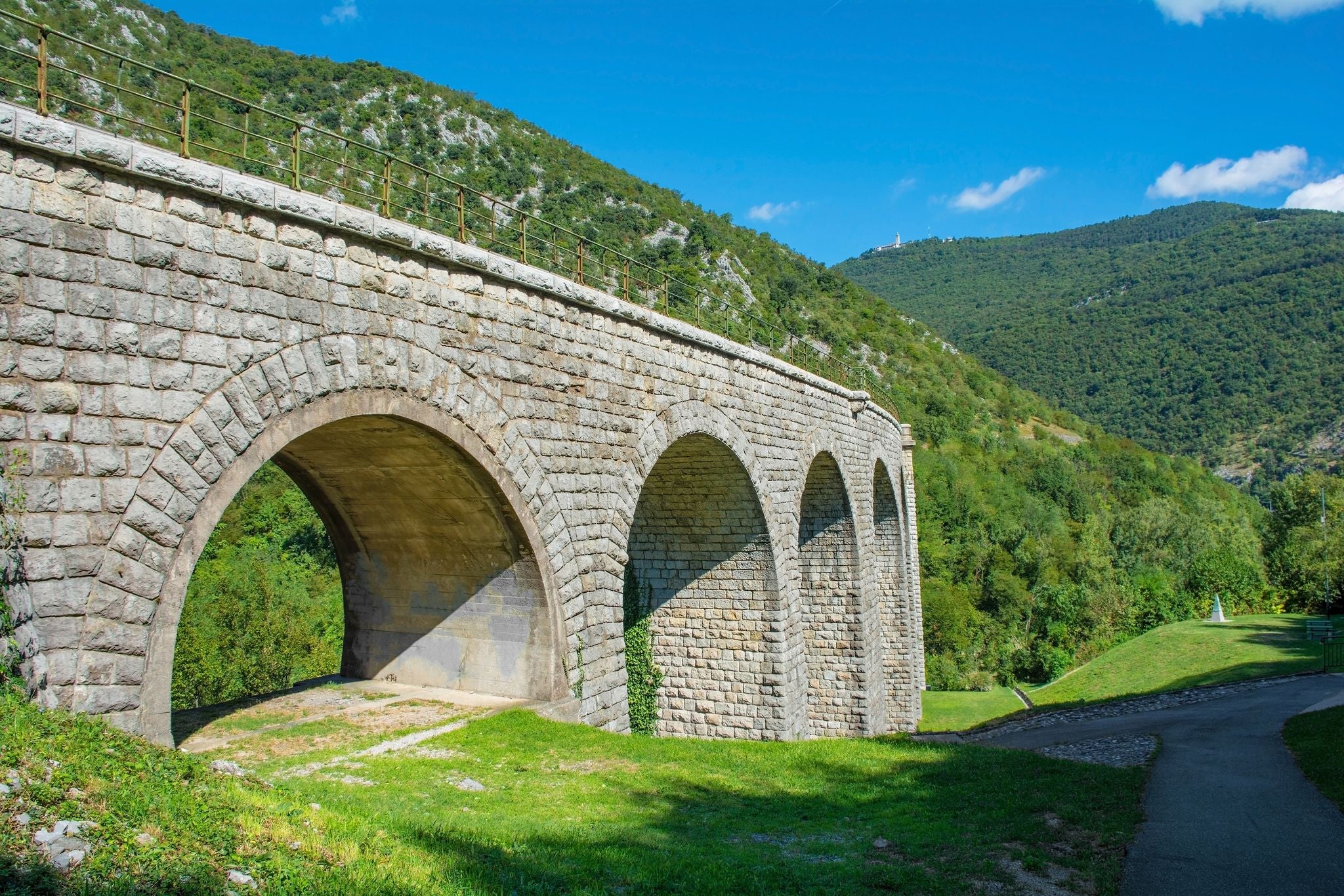 Solkan Bridge over Soca River at Solkan, Nova Gorica, Primorska, Slovenia. The longest stone arch railroad bridge in the world, 2nd longest stone arch bridge. Soca Valley karst landscape. Mt Sabotin