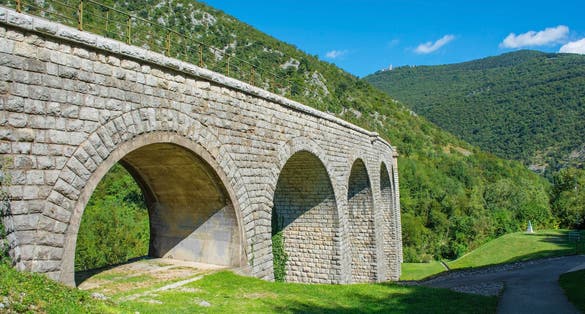 Solkan Bridge over Soca River at Solkan, Nova Gorica, Primorska, Slovenia. The longest stone arch railroad bridge in the world, 2nd longest stone arch bridge. Soca Valley karst landscape. Mt Sabotin