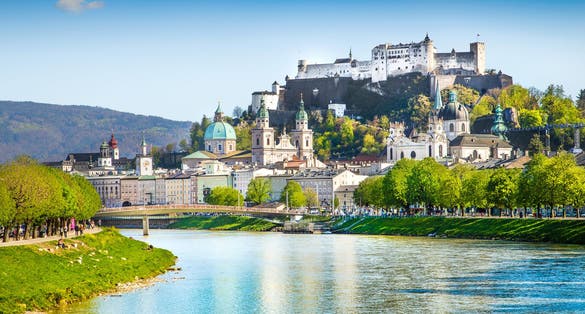 Photo of beautiful view of Salzburg skyline with Festung Hohensalzburg and Salzach river in summer, Salzburg, Salzburger Land, Austria.