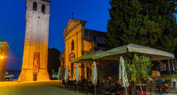 Photo of Cathedral of the Assumption of the Blessed Virgin Mary with clock tower at night in Pula city in Croatia.