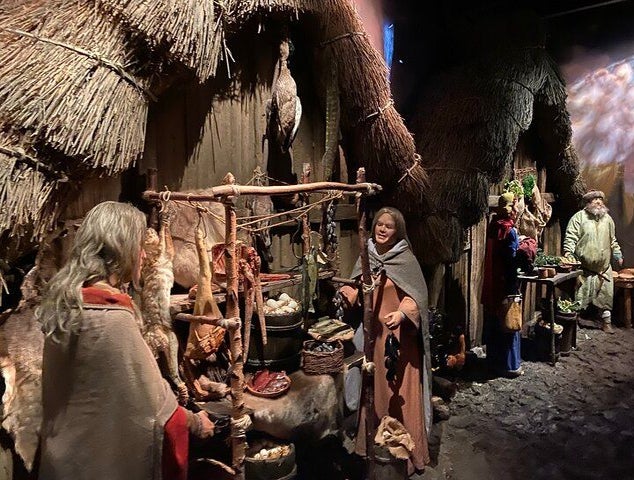 A historic market scene with lifelike Viking-era figures displayed at the Jorvik Viking Centre..jpg