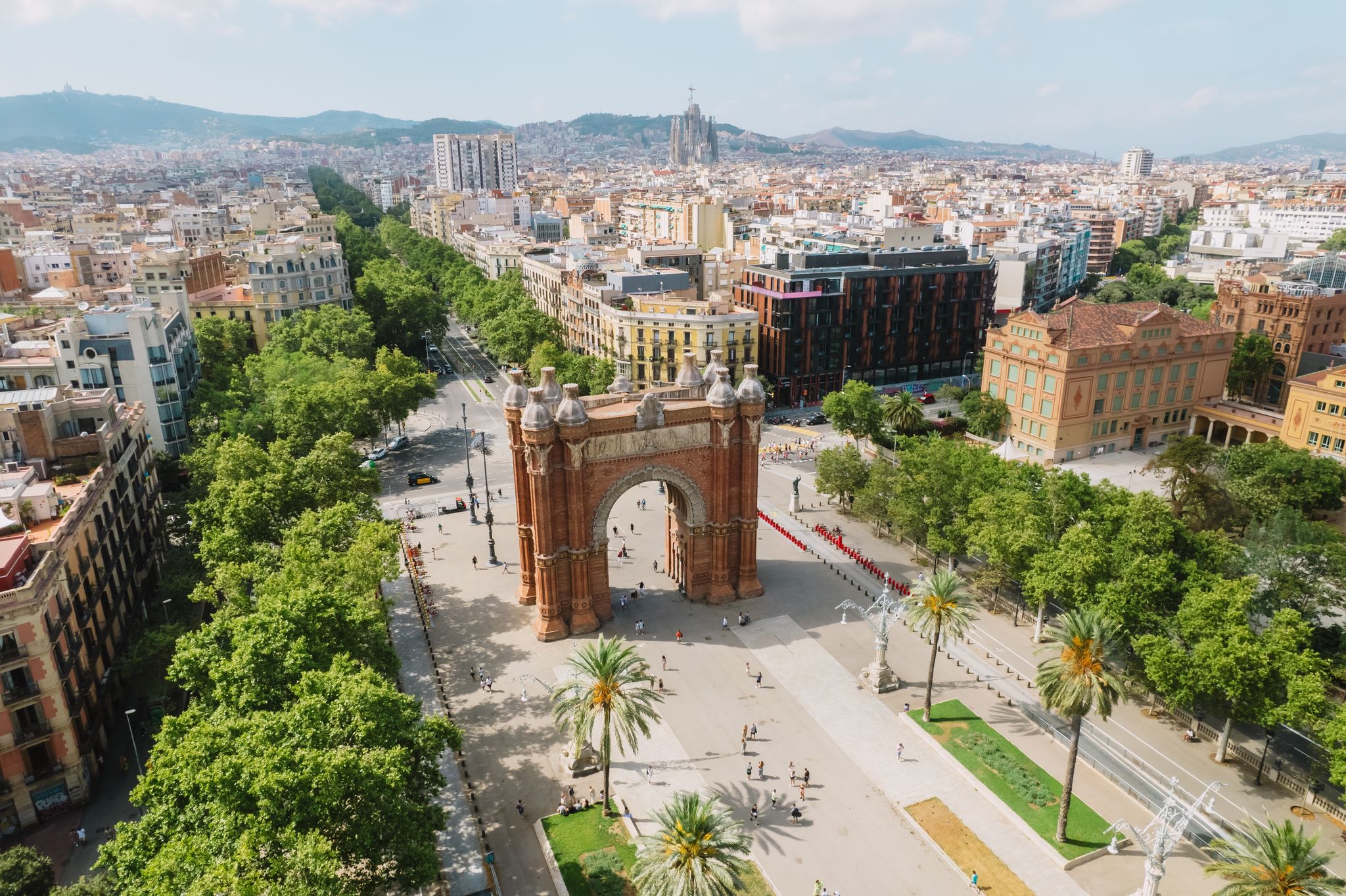 Photo of aerial view of Barcelona Urban Skyline and The Arc de Triomf or Arco de Triunfo in spanish, a triumphal arch in the city of Barcelona.