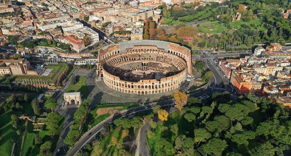 photo of aerial drone photo of iconic ancient Roman gladiatorial arena world famous colosseum, Rome historic center, Italy.