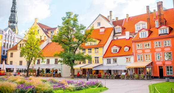 Photo of Livu square with beautiful flowerbed and buildings in the old town of Riga, Latvia.