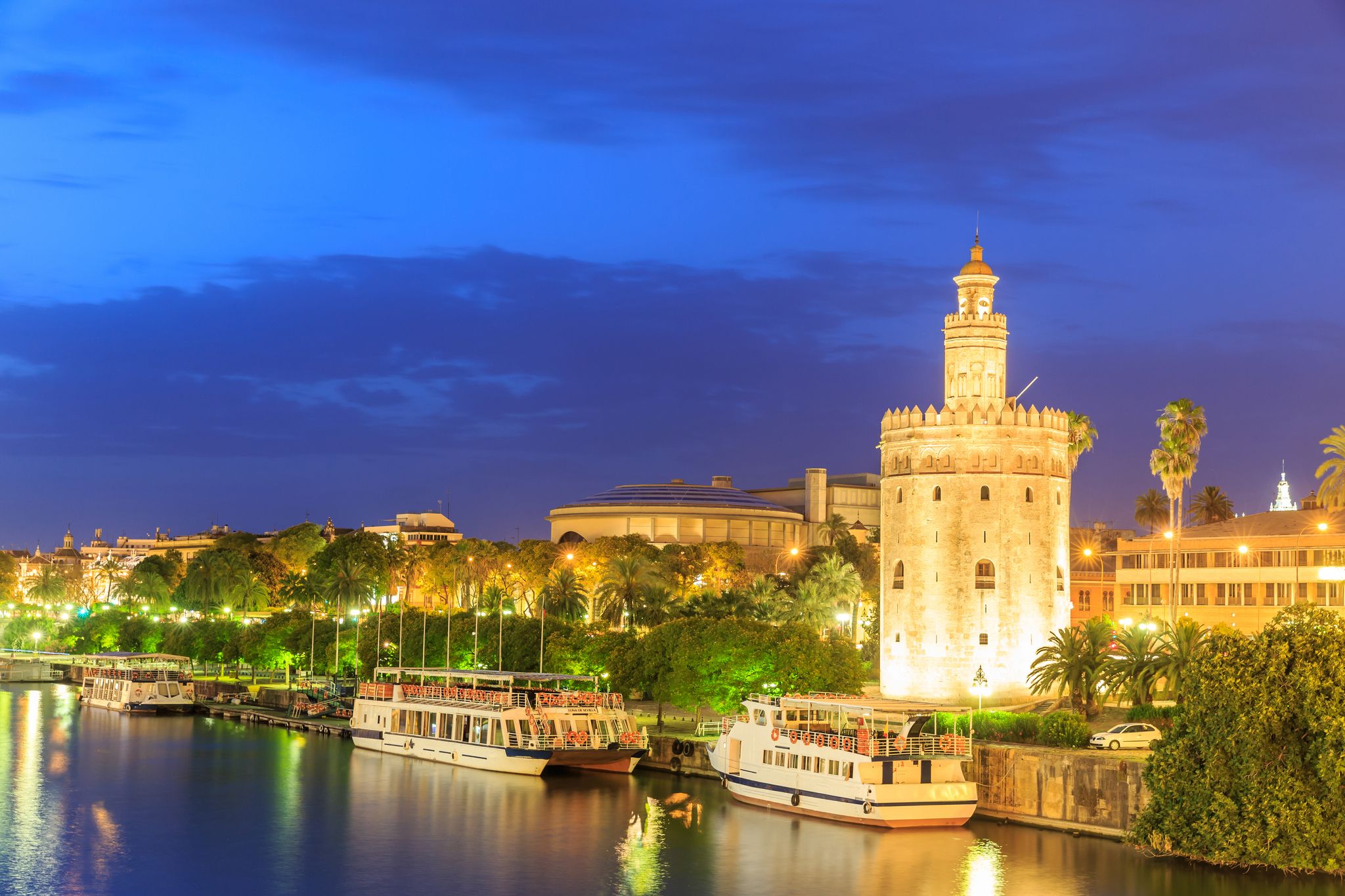 Photo of Golden Tower (Torre del Oro) of Seville, Andalusia, Spain over river Guadalquivir at sunset .