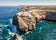 Photo of aerial view of beautiful lighthouse located on high cliffs of Saint Vincent cape in Sagres, Algarve, Portugal.