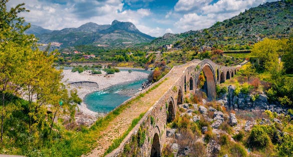photo of attractive spring view of Old Mes Bridge. Majestic morning landscape of Shkoder. Wonderful outdoor scene of Albania, Europe. Traveling concept background.