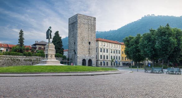 Como city, historic center, lake Como, Italy. Picturesque view, square Vittoria and medieval tower (12th century) called Porta Torre. Itinerary and travel destination in northern Italy.