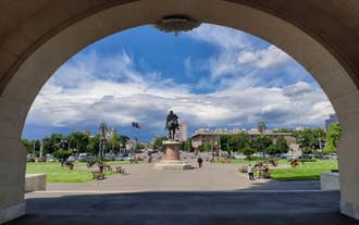 Photo of Water fountain in central square in Iasi town, Cultural Palace in background, Moldavia, Romania.
