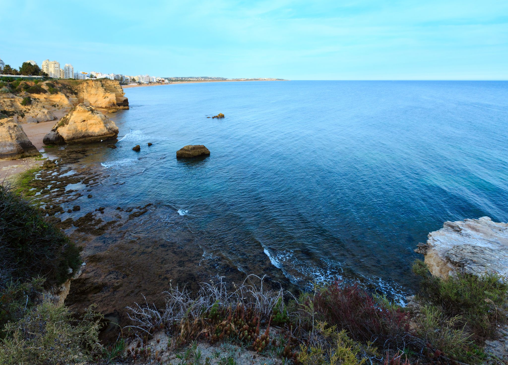 Beach Praia dos Beijinhos summer evening view. Atlantic coast landscape (Lagoa, Algarve, Portugal).
