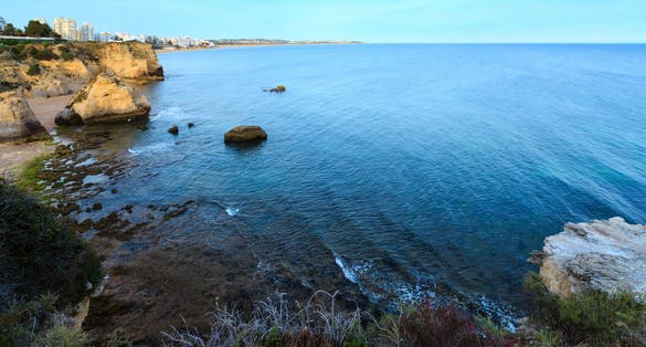 Beach Praia dos Beijinhos summer evening view. Atlantic coast landscape (Lagoa, Algarve, Portugal).