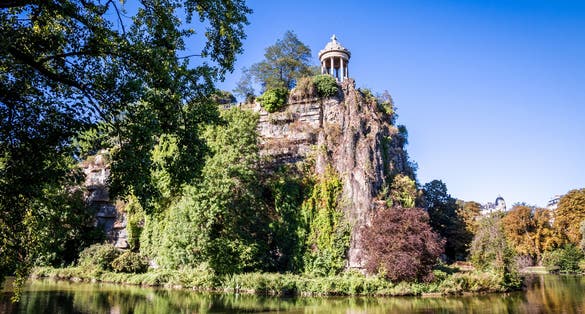 photo of Sibyl temple and lake in Buttes-Chaumont Park, Paris, France.