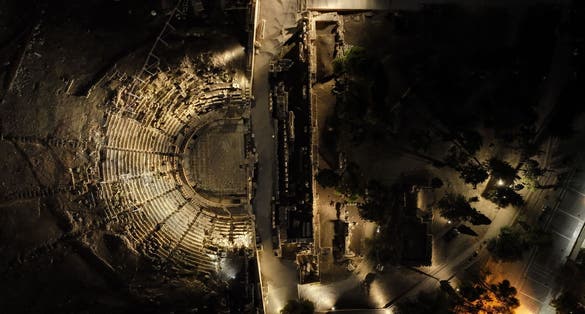 photo of Aerial drone night shot of iconic Theatre of Dionysus in the slopes of Acropolis hill, Athens historic centre, Attica, Greece,Athens Greece.