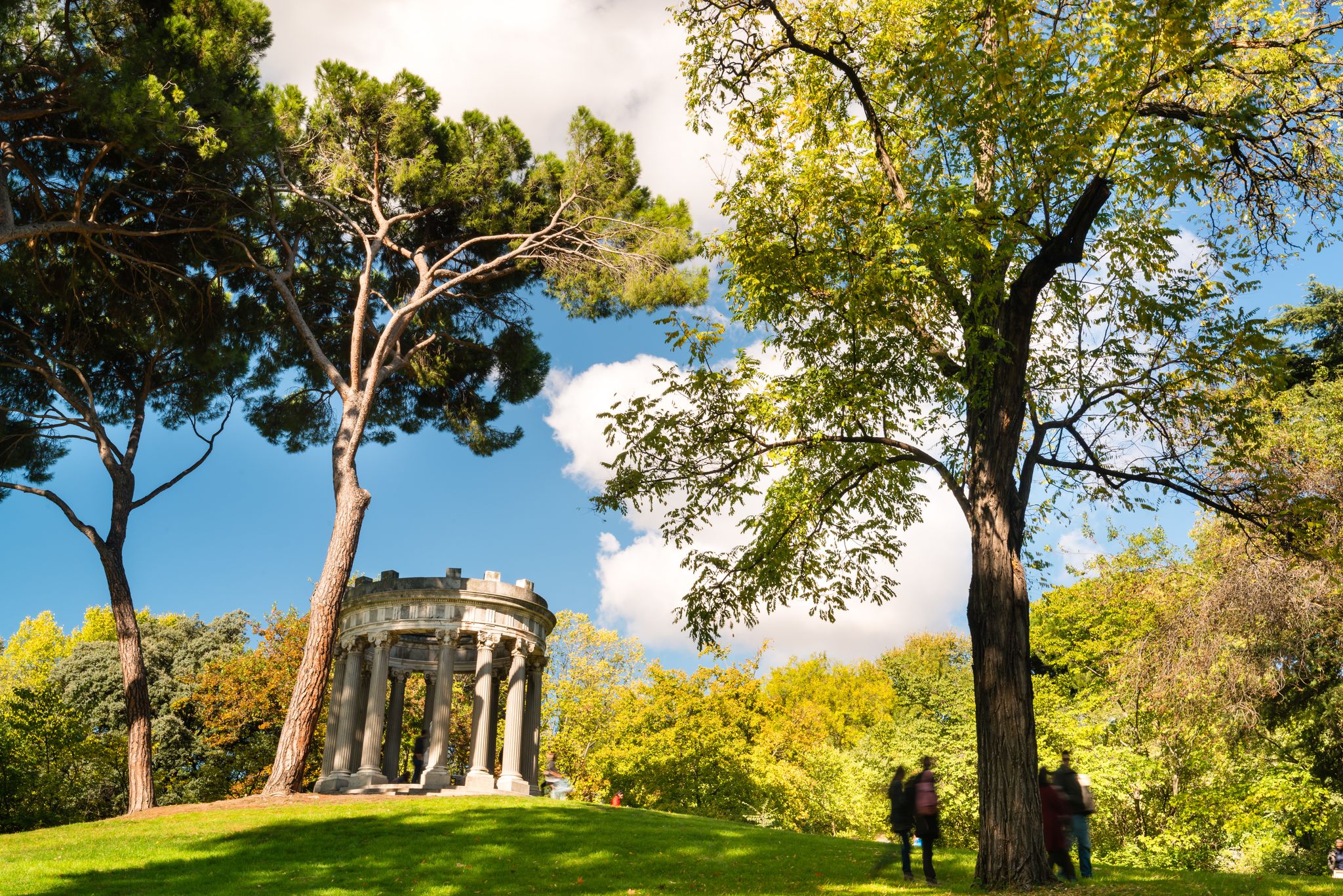 Photo of Small roman style temple with a goddess statue inside, sited at the "El Capricho" public park, in Madrid, Spain.