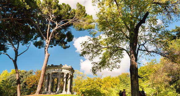 Photo of Small roman style temple with a goddess statue inside, sited at the "El Capricho" public park, in Madrid, Spain.