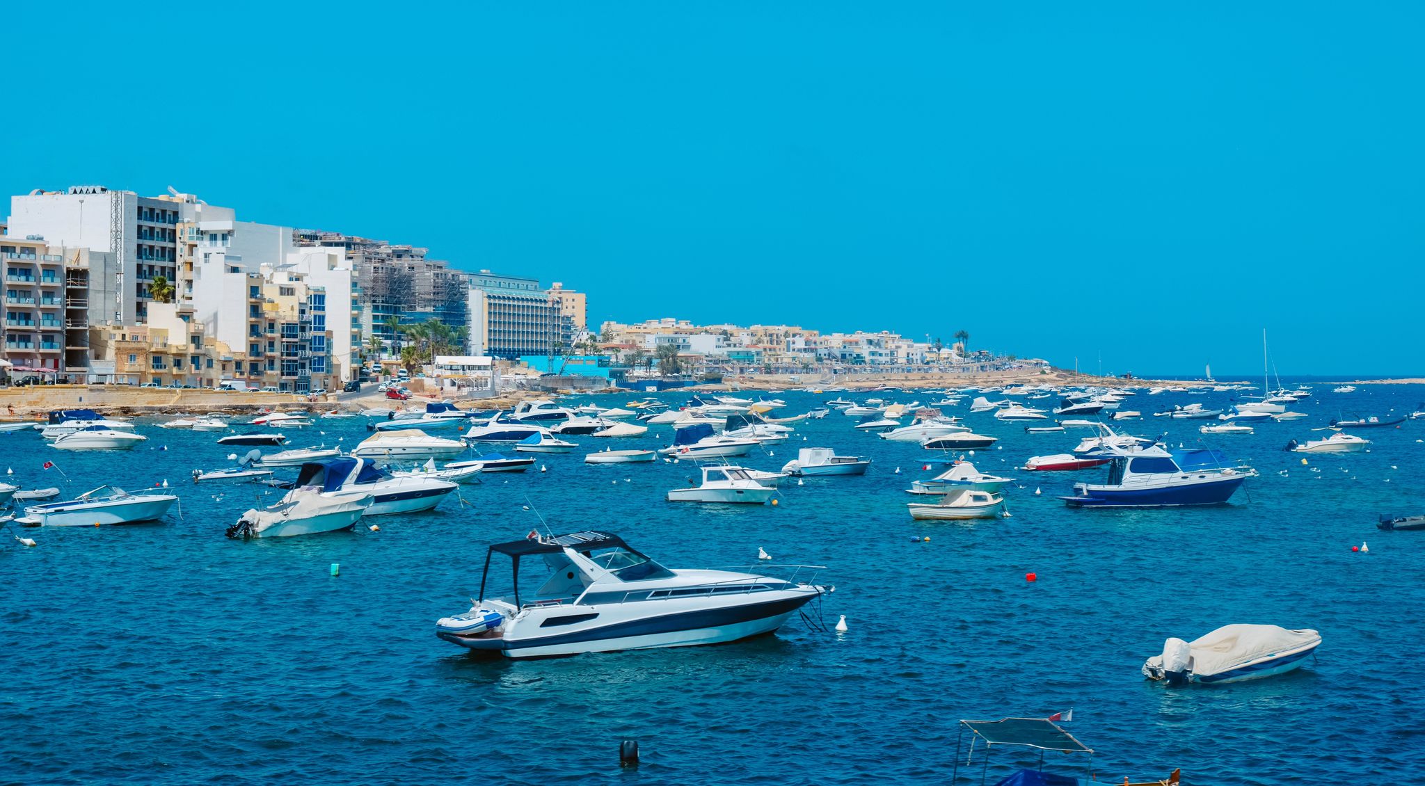 a view over Salina Bay in San Pawl il-Bahar, in Malta, with many nautical vessels moored in the sea