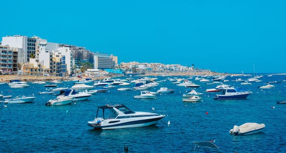 a view over Salina Bay in San Pawl il-Bahar, in Malta, with many nautical vessels moored in the sea