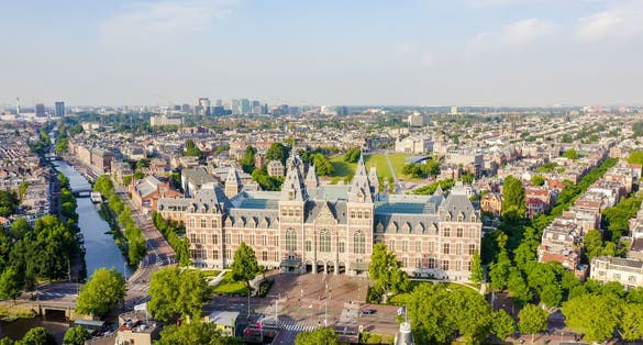 Amsterdam, Netherlands. Museum ( Rijksmuseum ). The building of the XIX century. Flying over the rooftops of the city, Aerial View