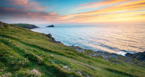 Photo of sunset on cliffs at West Pentire above Crantock near Newquay in Cornwall.