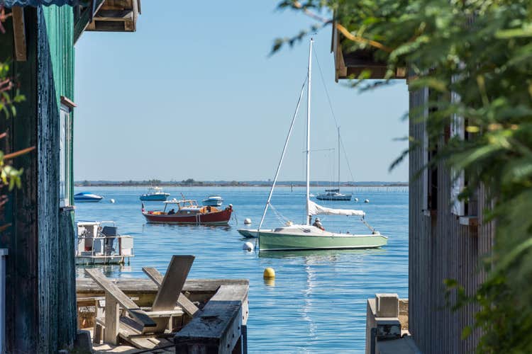 Small boats seen from an oyster village on the Arcachon Bay.