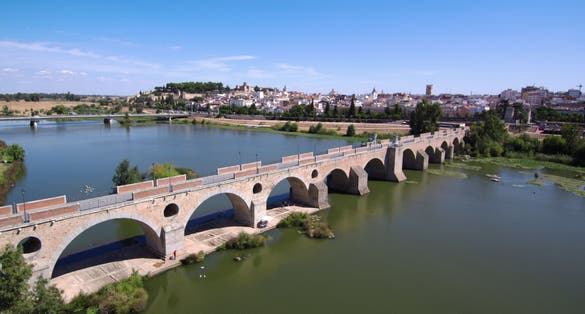photo of aerial view of Puente de Palmas and the River Guadiana in Badajoz, Spain.