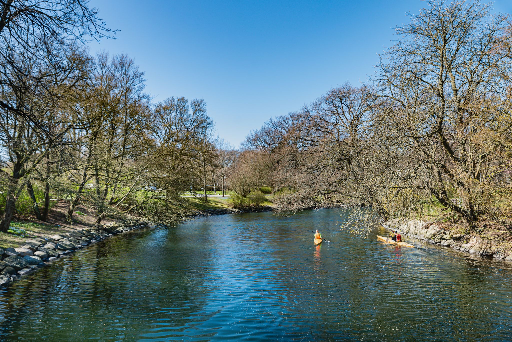 photo of canoeing around Slottstradgarden or Kungsparken sea canals. Boats are available to people for kayaking in this vibrant park and it is a common sport or activity in spring and summer in Malmo, Sweden.