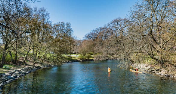 photo of canoeing around Slottstradgarden or Kungsparken sea canals. Boats are available to people for kayaking in this vibrant park and it is a common sport or activity in spring and summer in Malmo, Sweden.