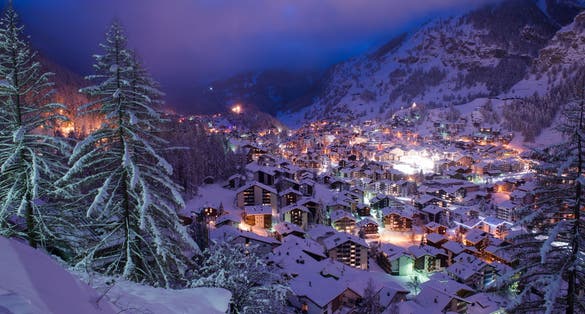 photo of aerial view on Zermatt valley and Matterhorn peak at dusk with fresh snow in Switzerland.