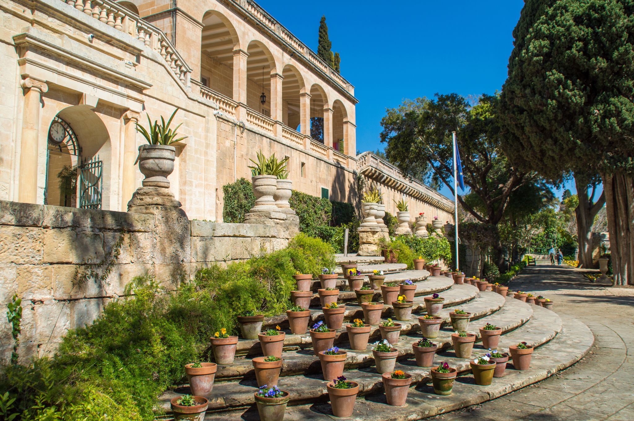 Photo of the Presidential Palace in San Anton Gardens, with flower pots on the stairs, in Attard, Malta.