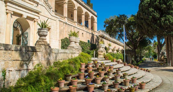 Photo of the Presidential Palace in San Anton Gardens, with flower pots on the stairs, in Attard, Malta.