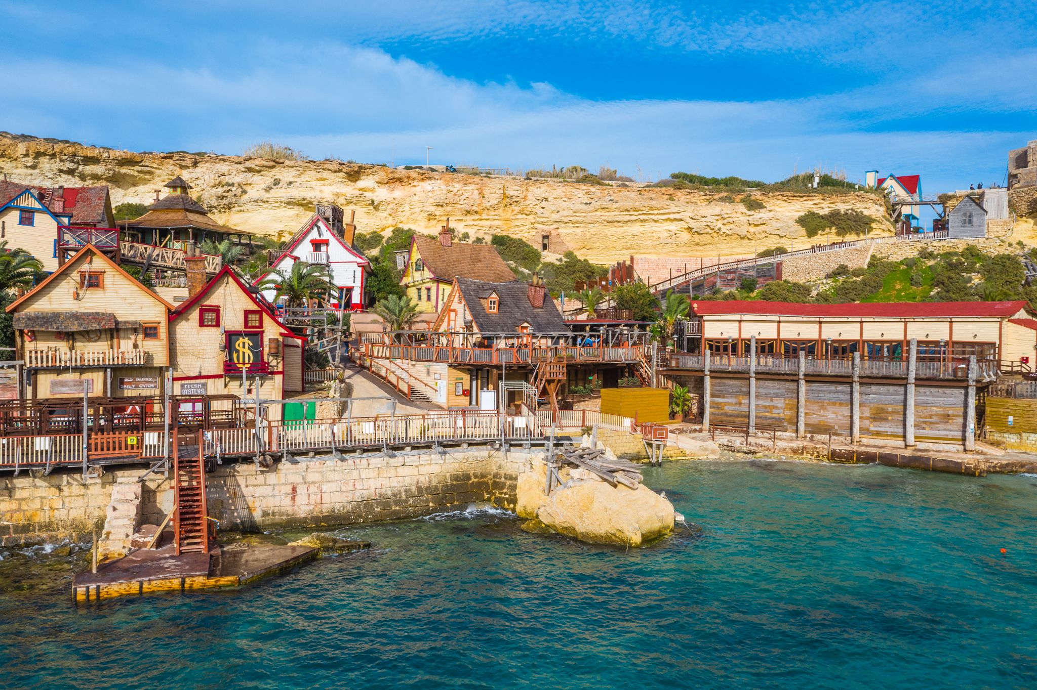 Photo of aerial view of famous Popeye village on a sunny day, Mellieha , Malta.