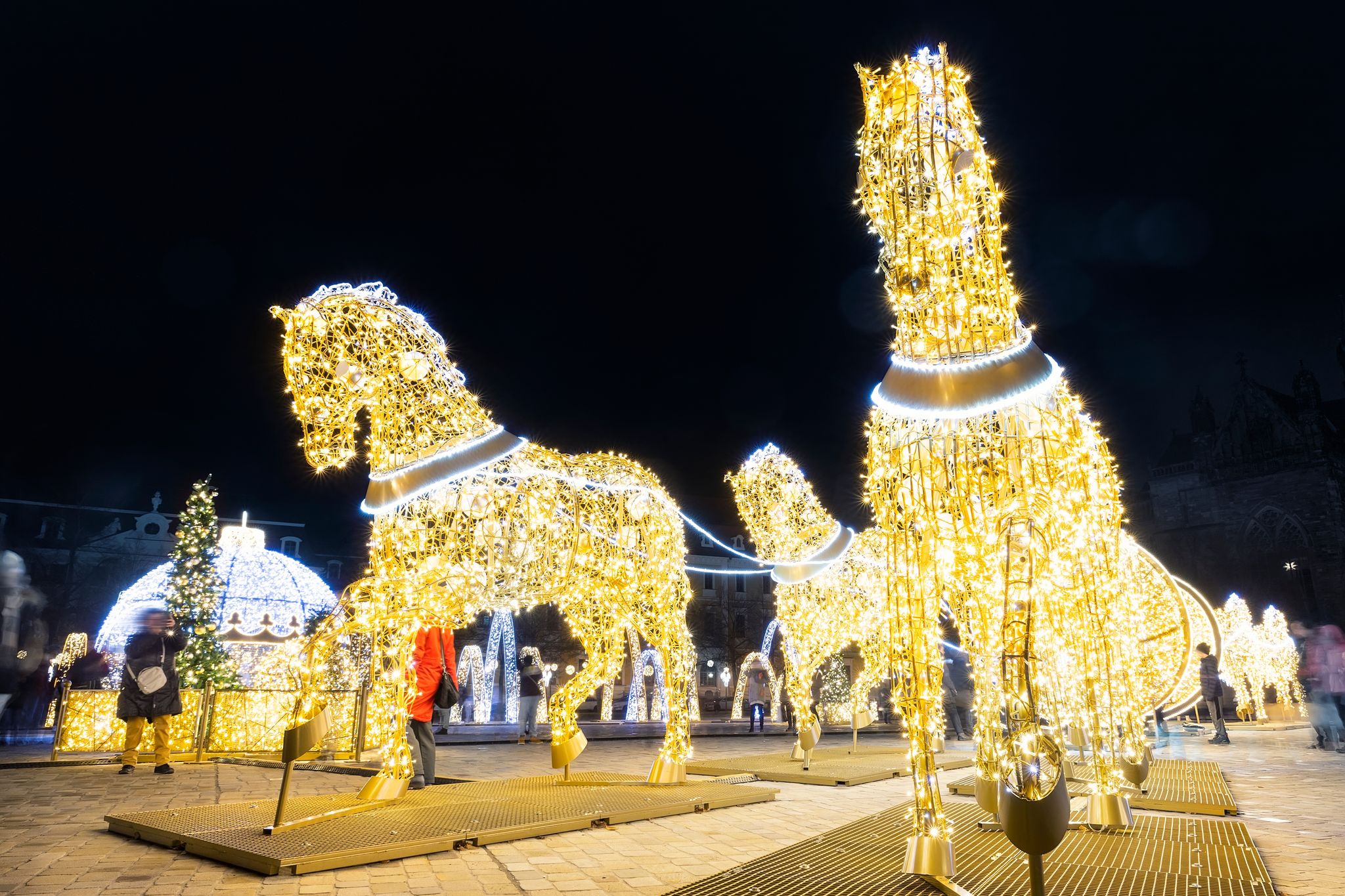 Scenic art light led lamp decoration figures of horse carriage, christmas tree bowl on Magdeburg Dom square. Light world lichterwelt city new year xmas in Germany Saxony-Anhalt