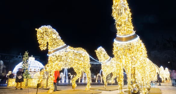 Scenic art light led lamp decoration figures of horse carriage, christmas tree bowl on Magdeburg Dom square. Light world lichterwelt city new year xmas in Germany Saxony-Anhalt