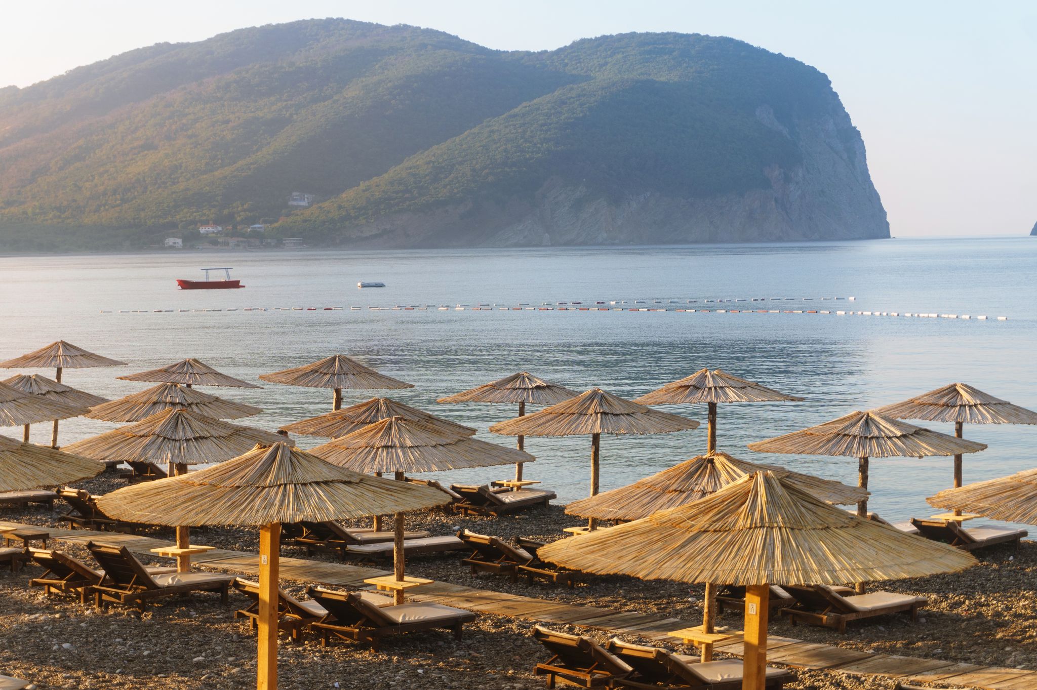 Photo of Cane parasols on the beautiful Buljarica beach, Montenegro.