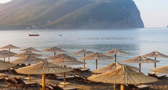 Photo of Cane parasols on the beautiful Buljarica beach, Montenegro.